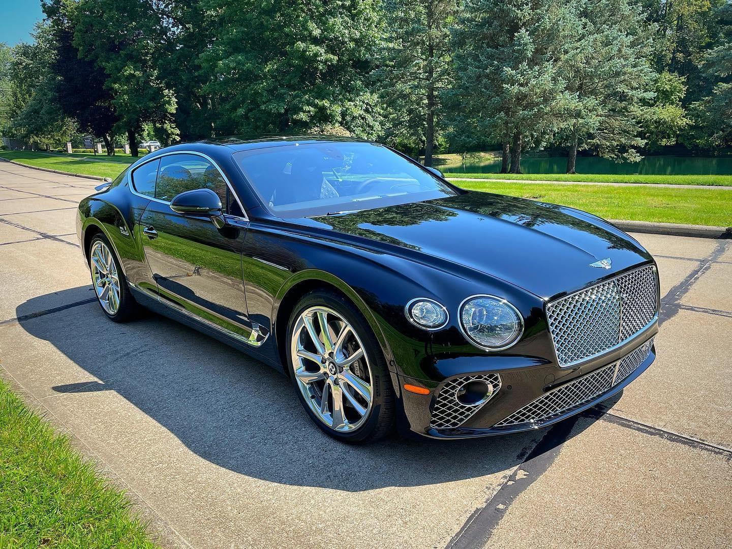 Black Bentley Continental GT with mirror-finish paint after a detail