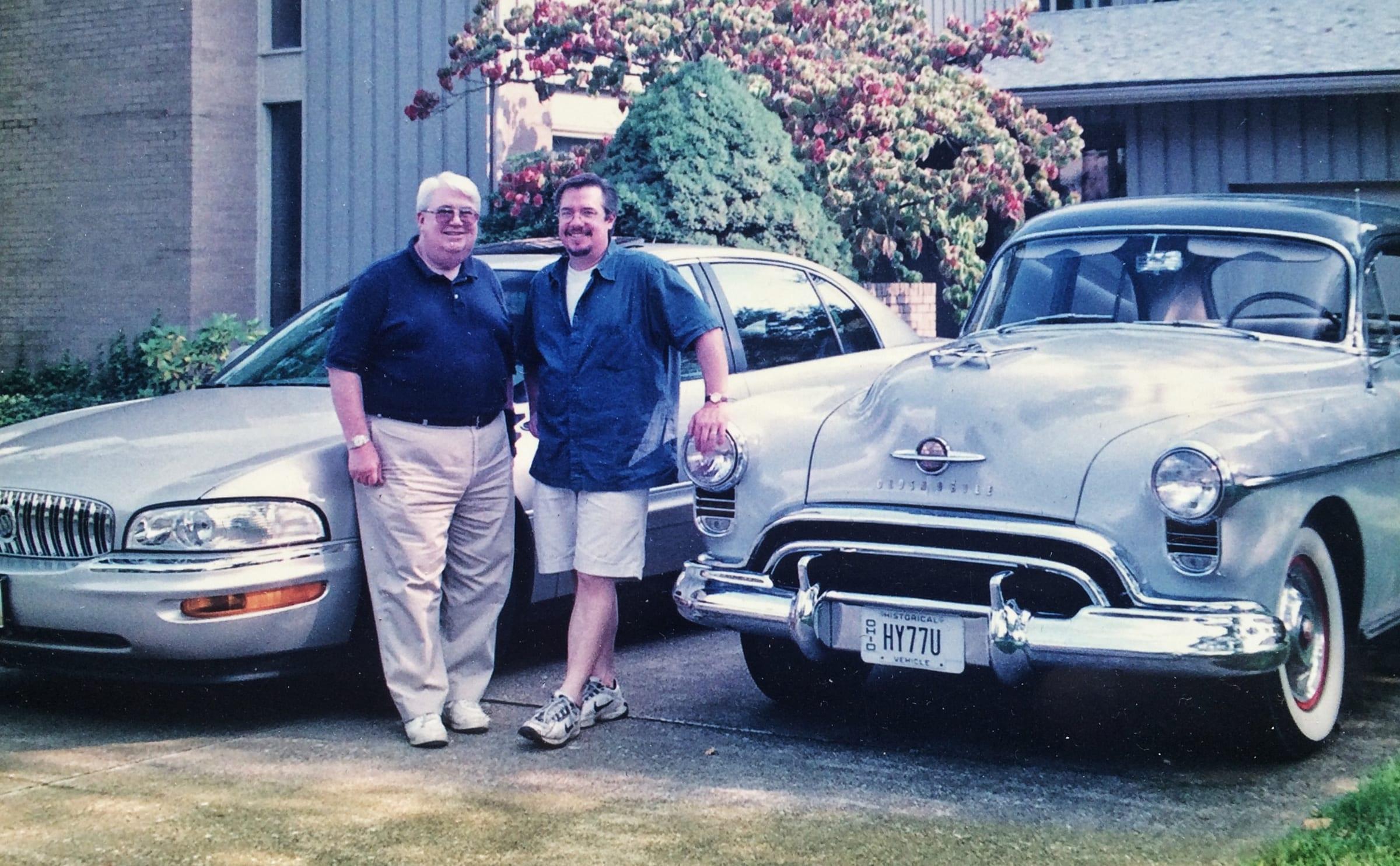 Bill and Eric standing with their 1950 Oldsmobile Rocket 88